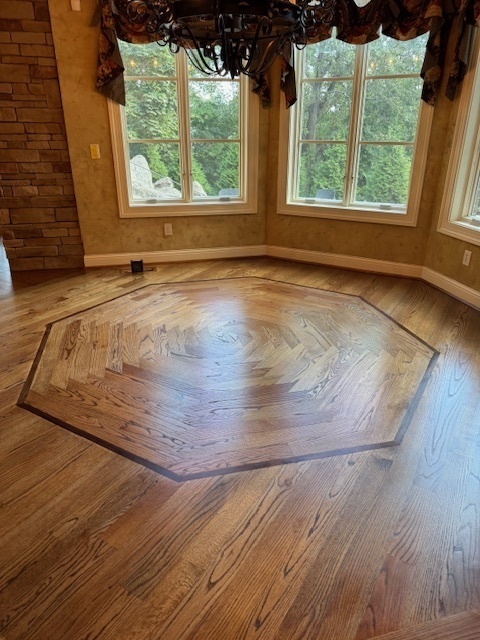 Custom hardwood floor design in a kitchen dining area